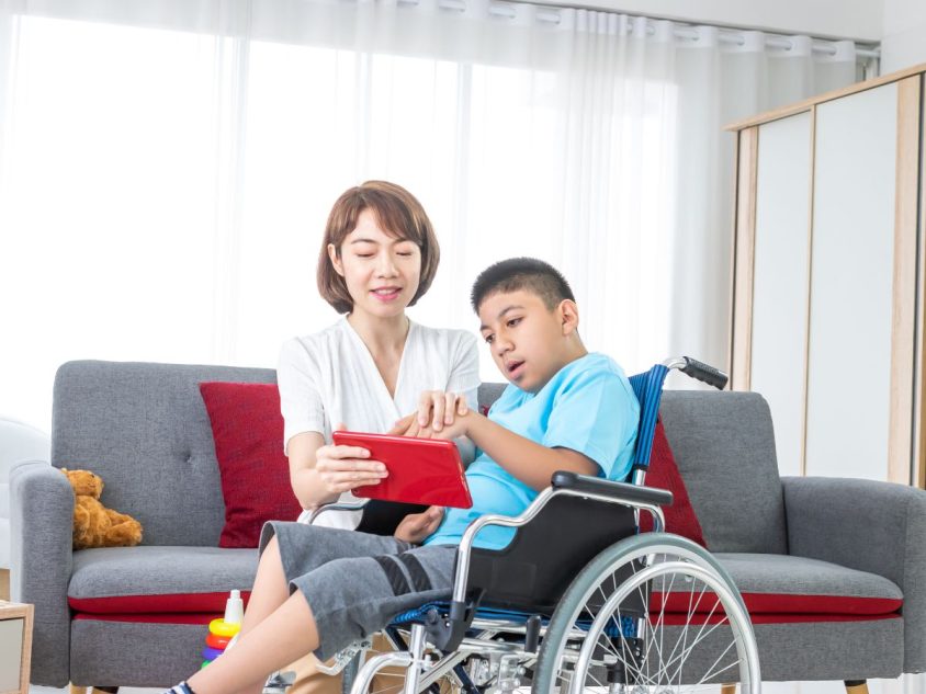 A woman taking care a disabled child | Homage